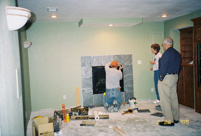 Putting up tile around fireplace